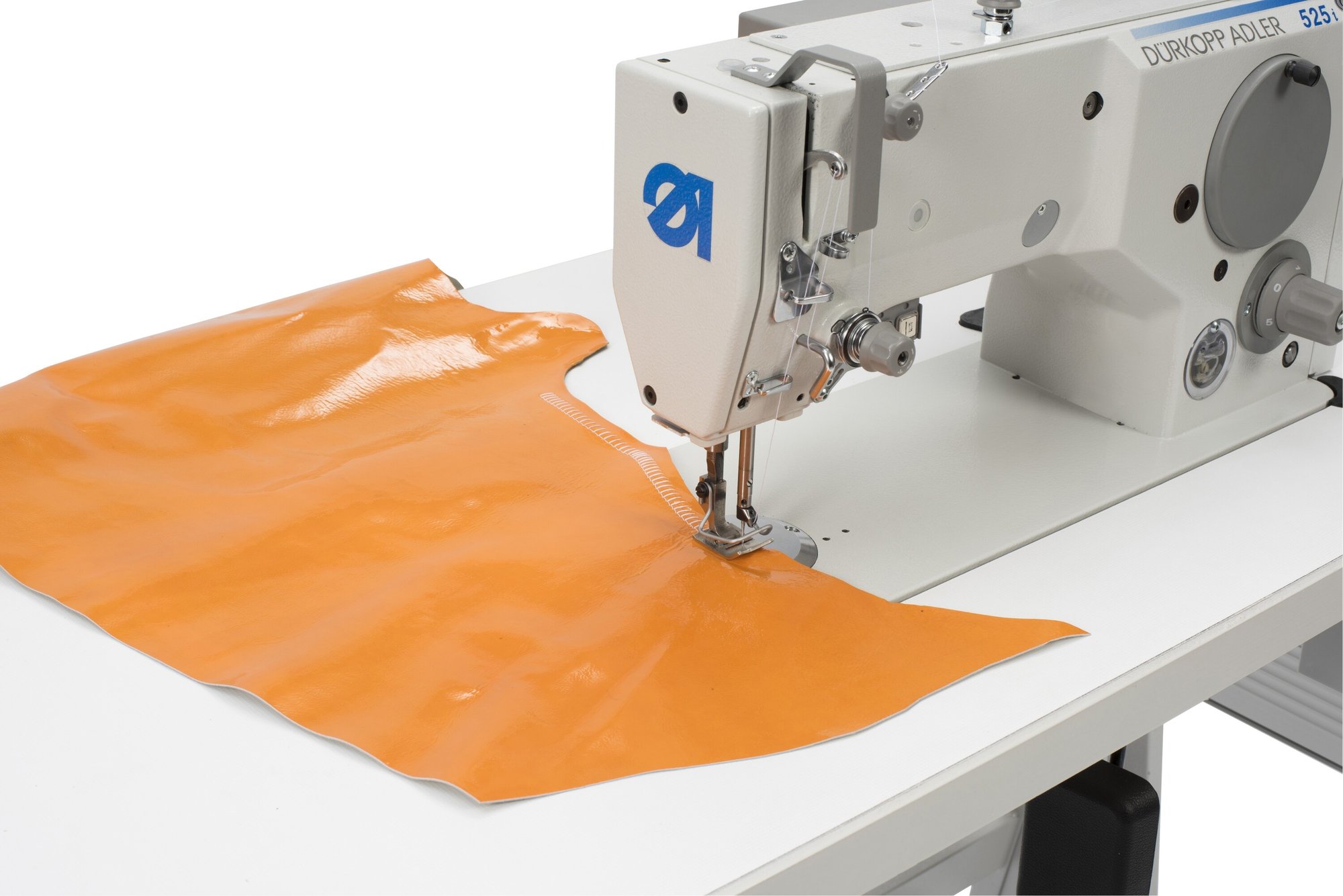 Durkopp Adler 525i sewing machine stitching a T-stitch seam on orange material