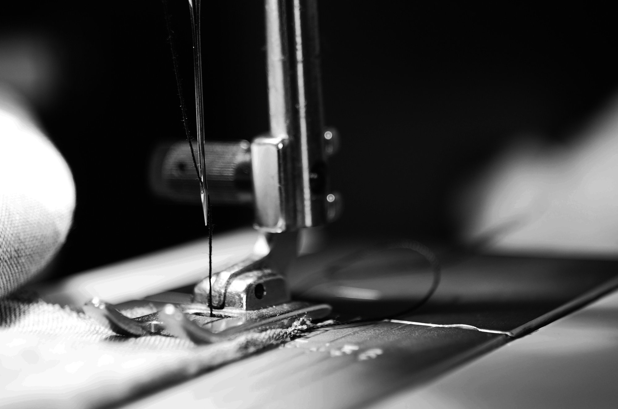 Close-up of industrial sewing machine needle at work, used for on-site technician training
