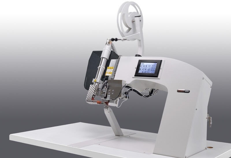 PFAFF 8303i hot-air taping machine with touchscreen on a work table